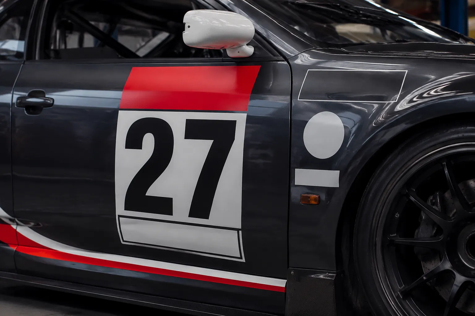 Race car door number panel shown with mandatory decal zones and nearby sponsor marks